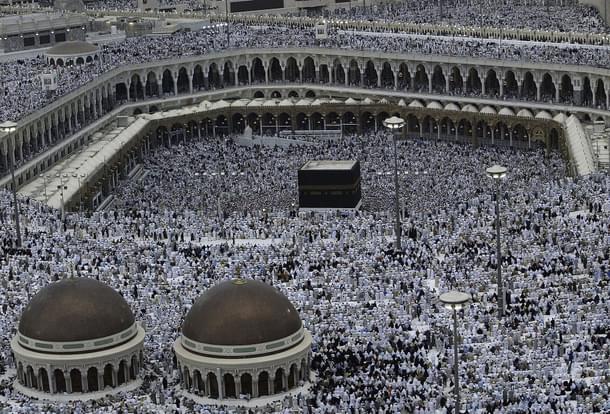 Muslim pilgrims pray the evening prayer inside the Grand Mosque and Holy Kabba, the holiest places for Muslims around the world  (Muhannad Fala’ah/Getty Images)